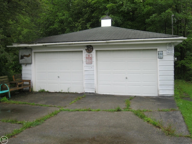 detached garage featuring a wooded view
