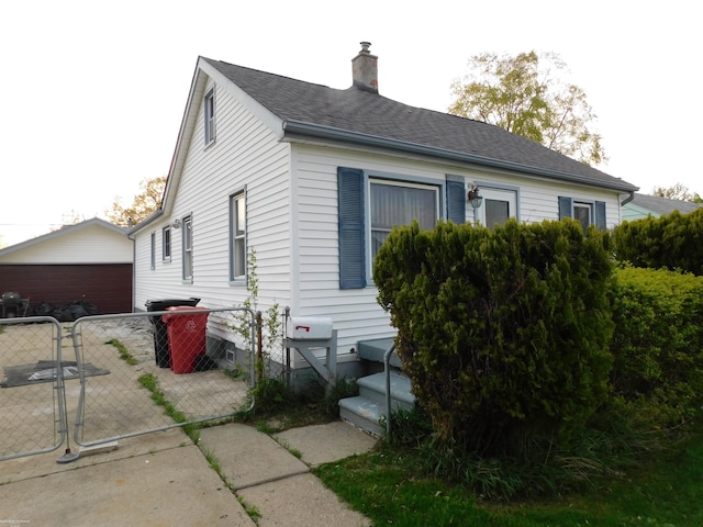 25697 Send St, Roseville, MI 48066 - view of side of property with a gate, a chimney, and a garage