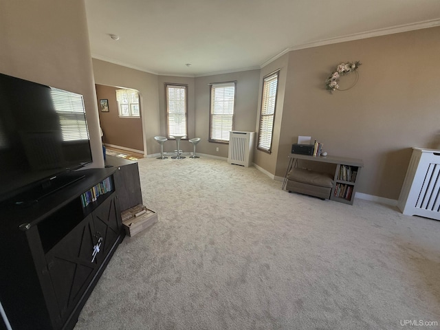 carpeted living area with crown molding, radiator heating unit, and baseboards