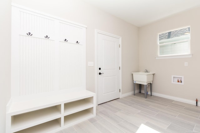 mudroom with baseboards and light wood-style flooring
