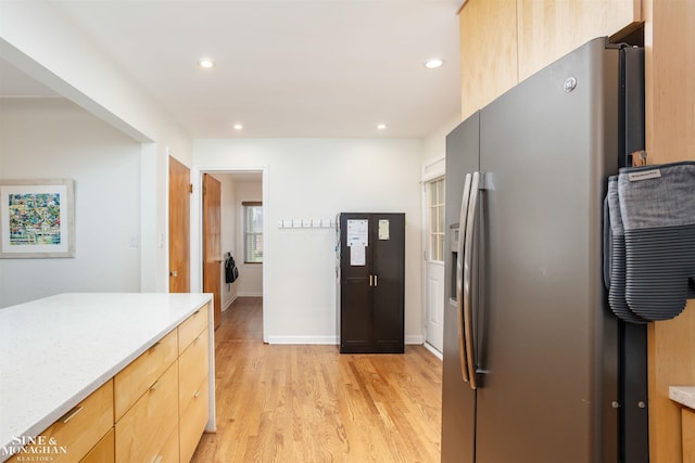 kitchen featuring stainless steel fridge with ice dispenser, light wood-style flooring, light brown cabinetry, recessed lighting, and baseboards