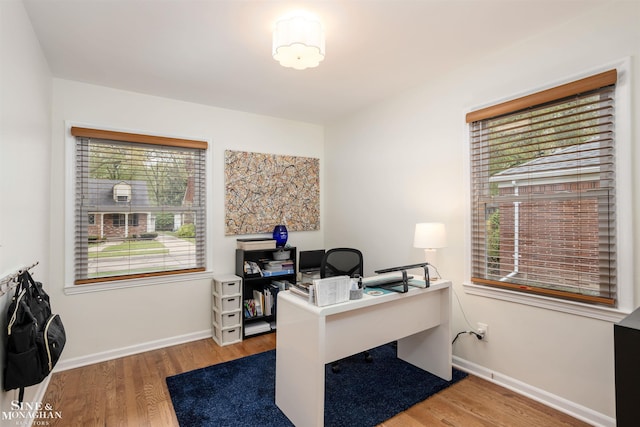 home office with wood finished floors and baseboards