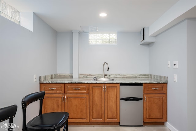 bar area featuring fridge and a sink