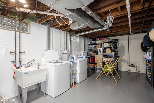 unfinished below grade area featuring independent washer and dryer and a sink