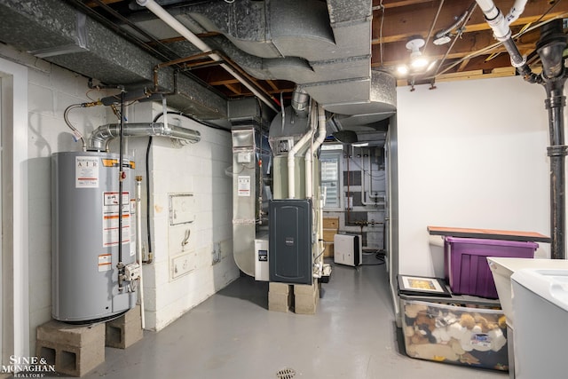 unfinished below grade area with gas water heater, heating unit, and concrete block wall