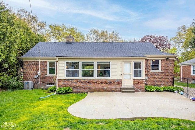 back of house featuring entry steps, central AC, a patio area, brick siding, and a chimney