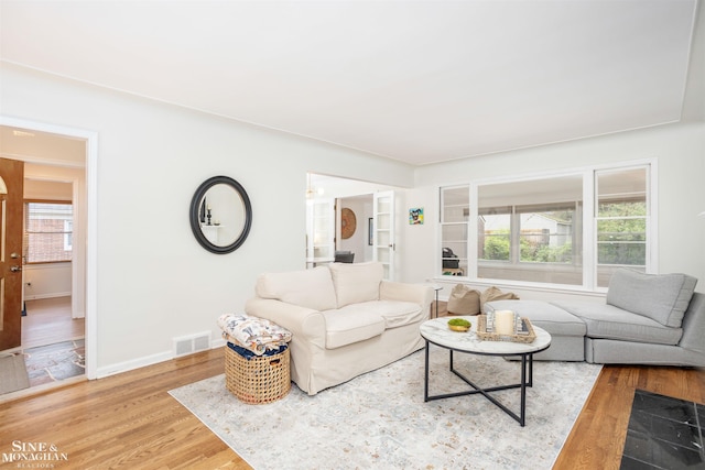 living room with light wood-type flooring and baseboards