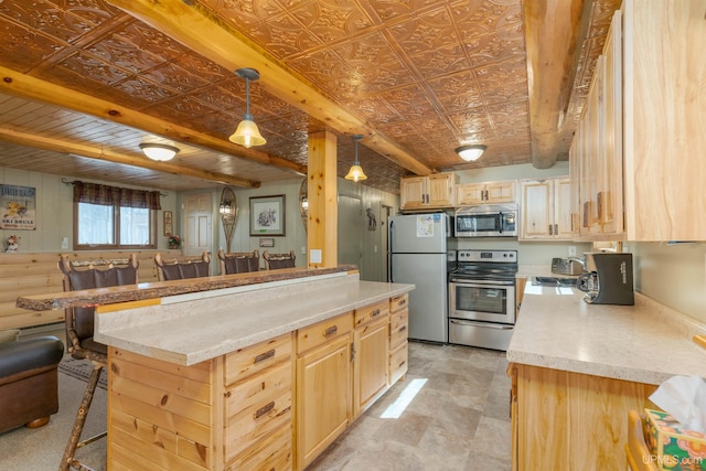 112 Little Deer Rd, Iron River, MI 49935 - kitchen with appliances with stainless steel finishes, an ornate ceiling, light brown cabinetry, a breakfast bar, and a sink
