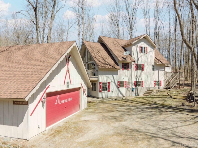 112 Little Deer Rd, Iron River, MI 49935 - view of front of property with stairs, dirt driveway, and roof with shingles