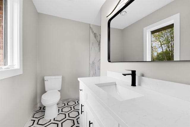 bathroom featuring toilet and vanity