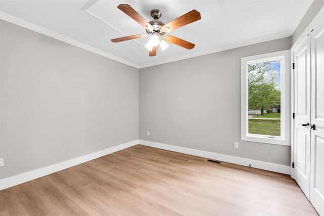 unfurnished bedroom featuring crown molding, light wood finished floors, baseboards, and a ceiling fan