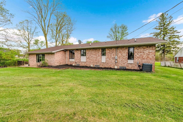 back of property featuring central AC unit and brick siding
