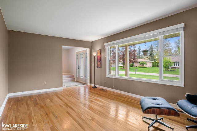 unfurnished room with baseboards and light wood-type flooring