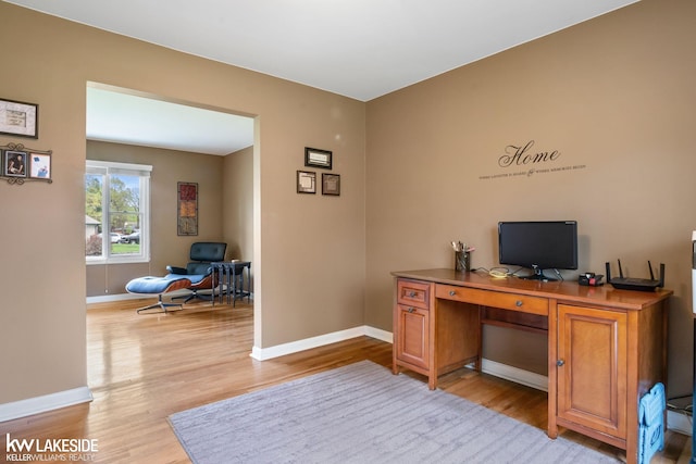 home office featuring light wood finished floors and baseboards
