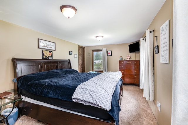 bedroom featuring light colored carpet