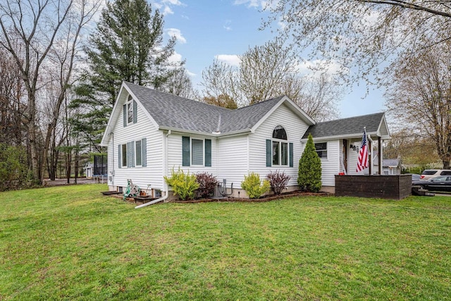 single story home featuring a shingled roof and a front lawn