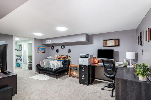 carpeted office featuring baseboards