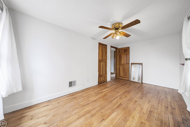 unfurnished bedroom with light wood-type flooring, baseboards, and a ceiling fan