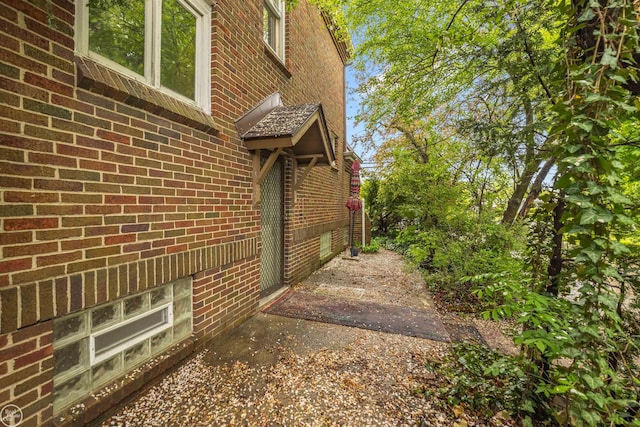 view of side of property with brick siding
