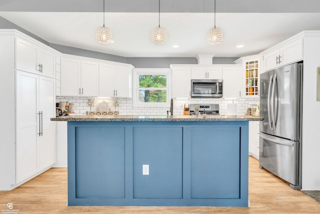kitchen with stainless steel appliances, glass insert cabinets, decorative backsplash, white cabinets, and recessed lighting