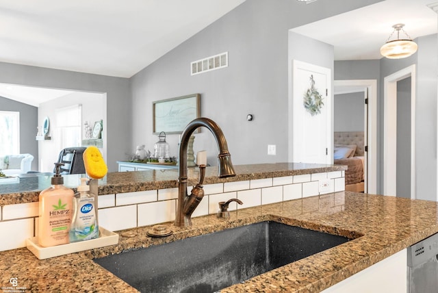kitchen view of a sink and white cabinets