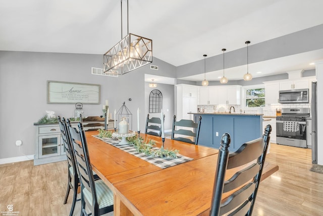 dining space featuring light wood finished floors and baseboards