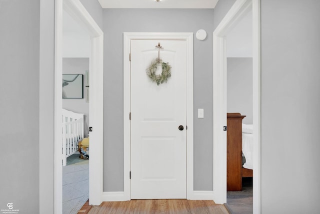 foyer entrance featuring light wood finished floors and baseboards