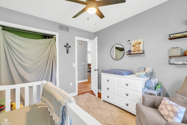 bedroom featuring light tile patterned flooring, ceiling fan, and baseboards