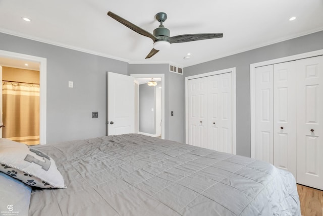 bedroom featuring ornamental molding, multiple closets, wood finished floors, recessed lighting, and a ceiling fan