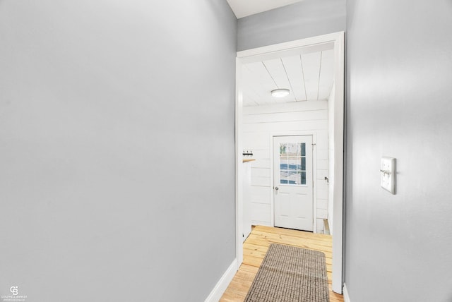 hallway with light wood-style flooring and baseboards