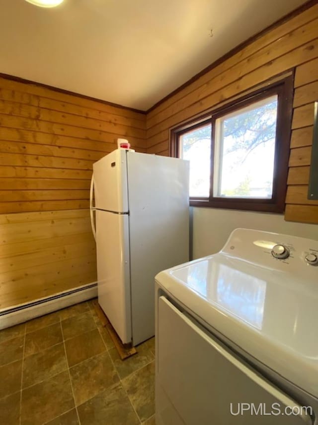 washroom with washer / clothes dryer, wooden walls, and baseboard heating