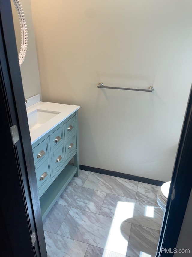 122 Rock St, Negaunee, MI 49866 - bathroom featuring vanity, marble look tile flooring, and baseboards