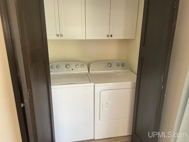 122 Rock St, Negaunee, MI 49866 - laundry area featuring washer and clothes dryer and cabinet space