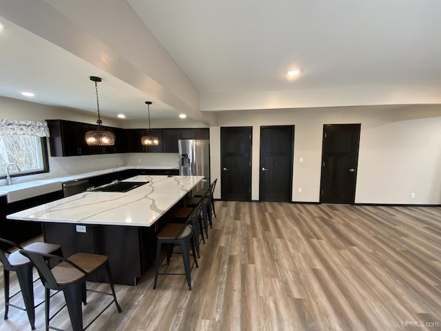 122 Rock St, Negaunee, MI 49866 - kitchen with stainless steel fridge with ice dispenser, light wood-type flooring, black electric stovetop, a sink, and dishwashing machine