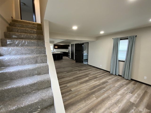 122 Rock St, Negaunee, MI 49866 - staircase featuring wood finished floors, recessed lighting, and baseboards