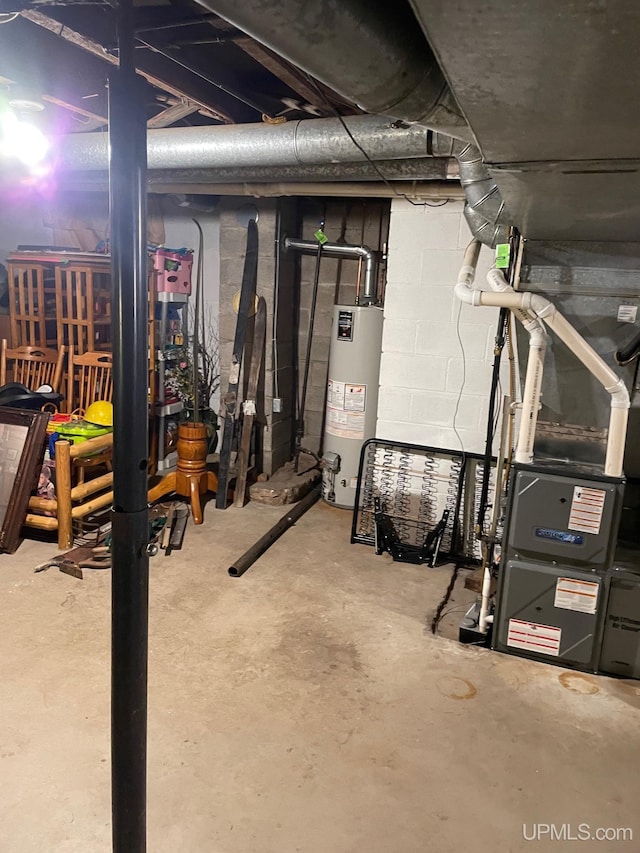 unfinished basement with gas water heater and heating unit