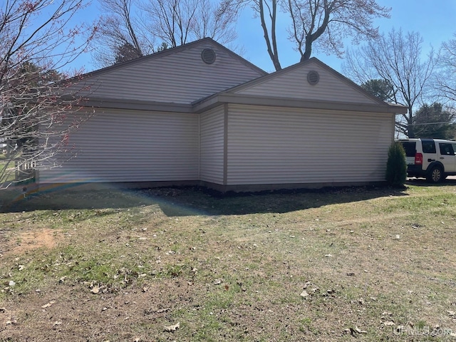 view of property exterior with a lawn