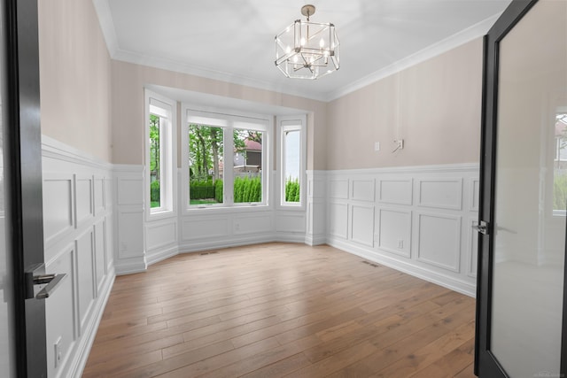 835 Crestwood Ln, Rochester Hills, MI 48309 - spare room with a decorative wall, plenty of natural light, a chandelier, a wainscoted wall, and ornamental molding