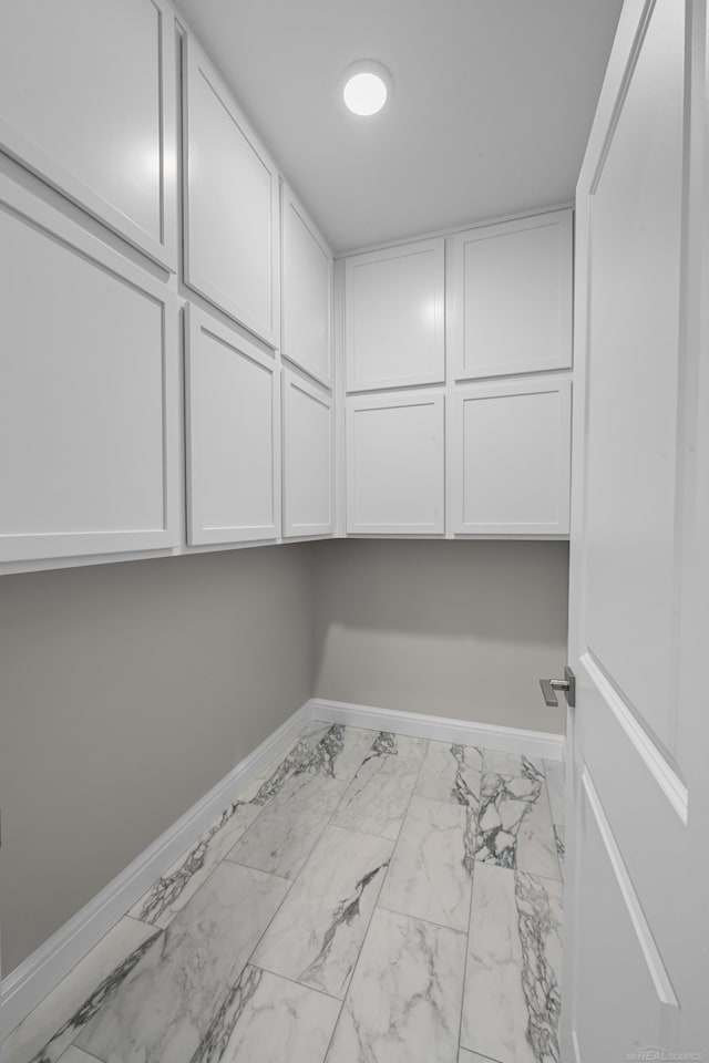 835 Crestwood Ln, Rochester Hills, MI 48309 - laundry area with marble look tile flooring and baseboards