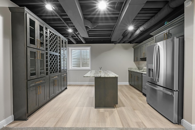 835 Crestwood Ln, Rochester Hills, MI 48309 - kitchen with stainless steel fridge, baseboards, light stone countertops, and light wood-style flooring