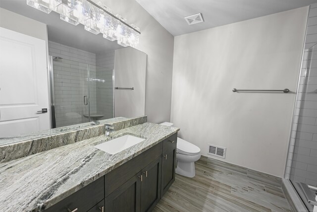 835 Crestwood Ln, Rochester Hills, MI 48309 - full bathroom with a stall shower, toilet, vanity, and wood finished floors