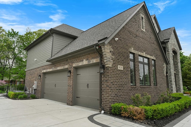 835 Crestwood Ln, Rochester Hills, MI 48309 - view of property exterior featuring brick siding, concrete driveway, a shingled roof, and a garage