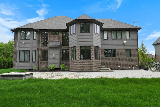 835 Crestwood Ln, Rochester Hills, MI 48309 - back of property featuring brick siding, a lawn, a patio, and a shingled roof