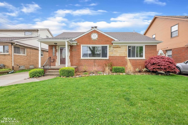 bungalow-style home with a front lawn, brick siding, and a shingled roof