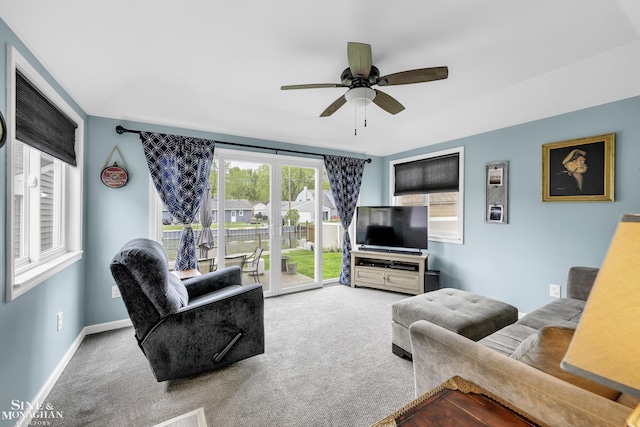 carpeted living room with a ceiling fan