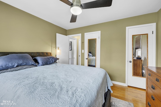 bedroom featuring light wood finished floors, a ceiling fan, and baseboards
