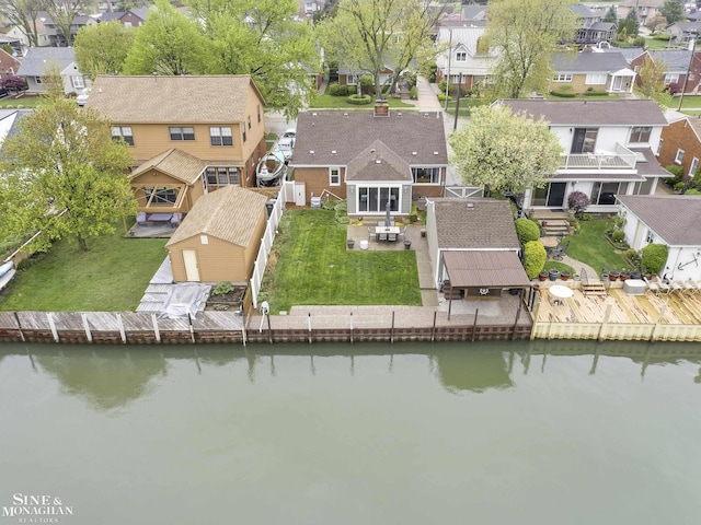aerial view of residential area featuring a nearby body of water