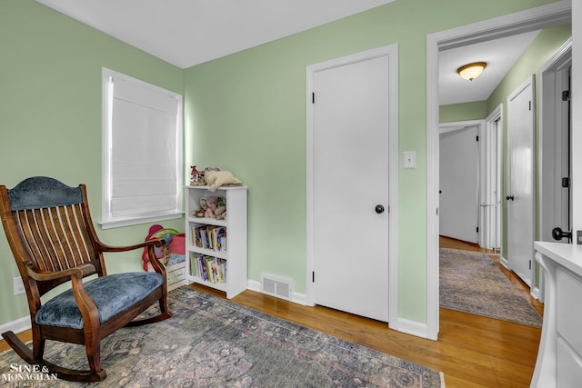 sitting room featuring wood finished floors and baseboards