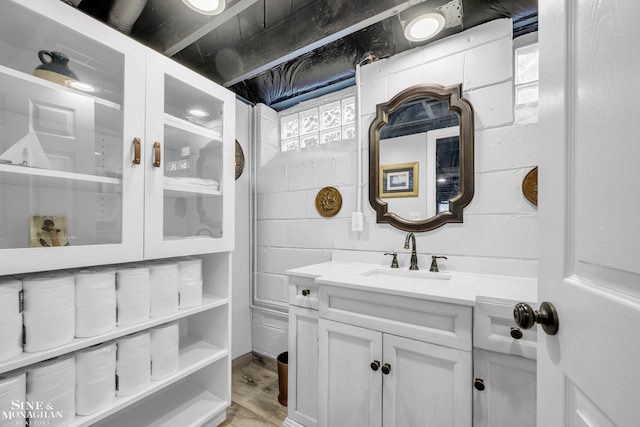 bathroom with vanity and wood finished floors
