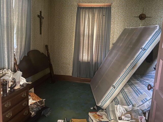 bedroom with carpet flooring and wallpapered walls